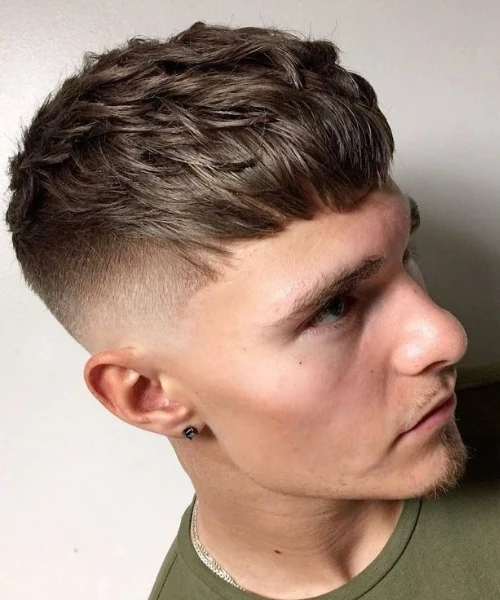 Textured crop men haircut with short sides and layered top